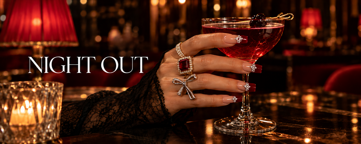 Night Out press-on nails – hand holding a cocktail in a candlelit bar – Briluxe