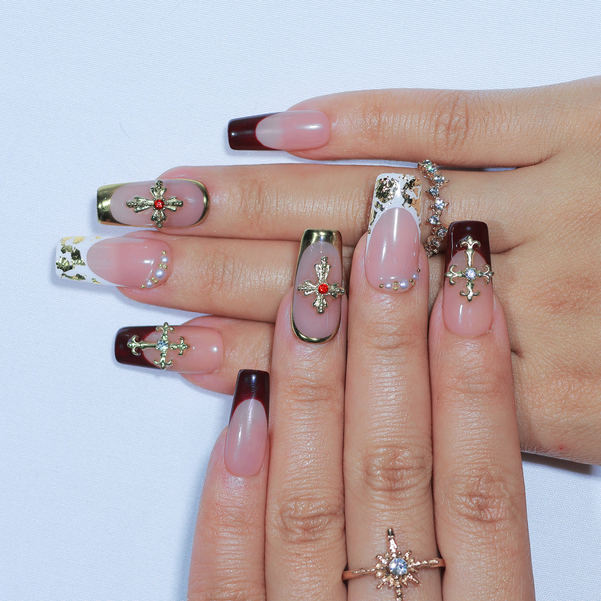 Saint Rouge medium square press-on nails, burgundy French tips with gold crosses – Briluxe (view 3)