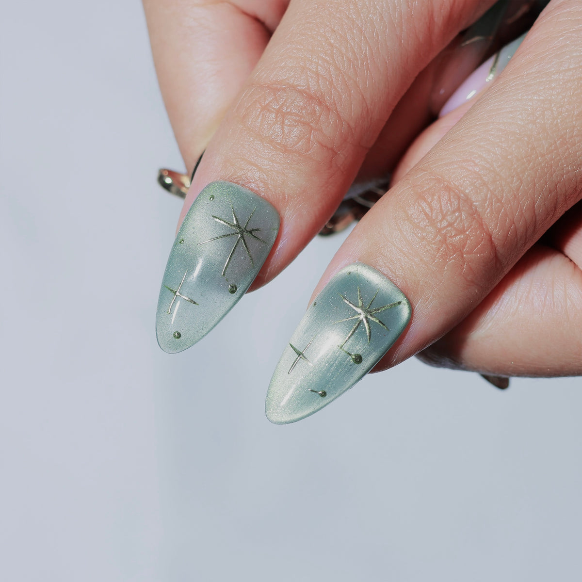 Lunar Sage medium almond press-on nails, sage green with moon and star details – Briluxe (view 5)